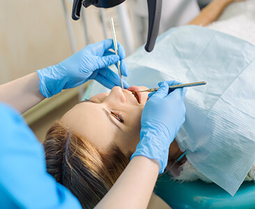 woman having her teeth examined