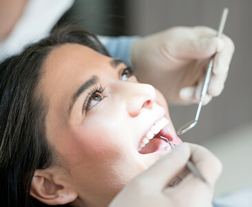 woman having her teeth examined