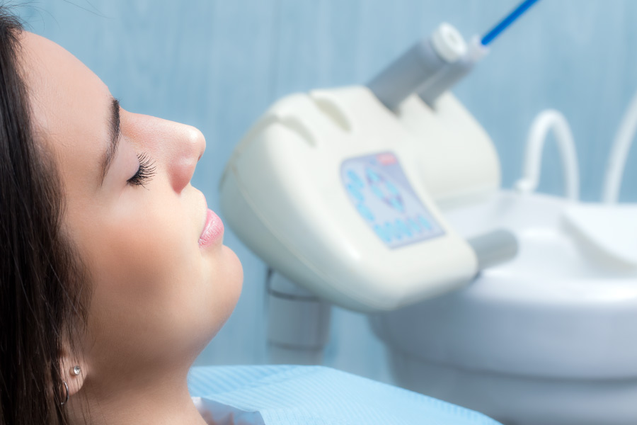 A woman relaxing in the dental chair after receiving oral conscious sedation.