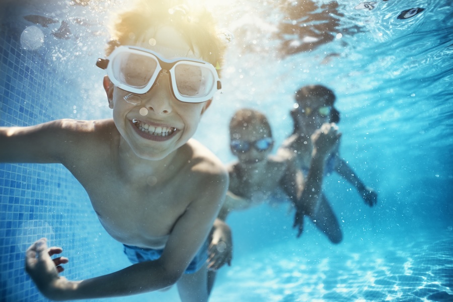 child swimming in summer, a great time for summer dental appointments with the slower summer pace