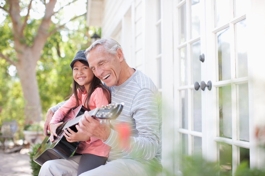 grandfather with his granddaughter smiling after getting oral health tips for seniors at the dentist